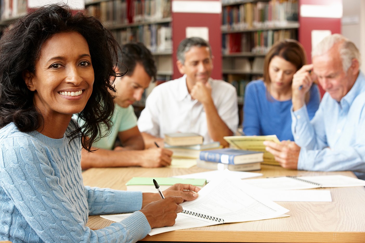 Canva - Mature students working in library